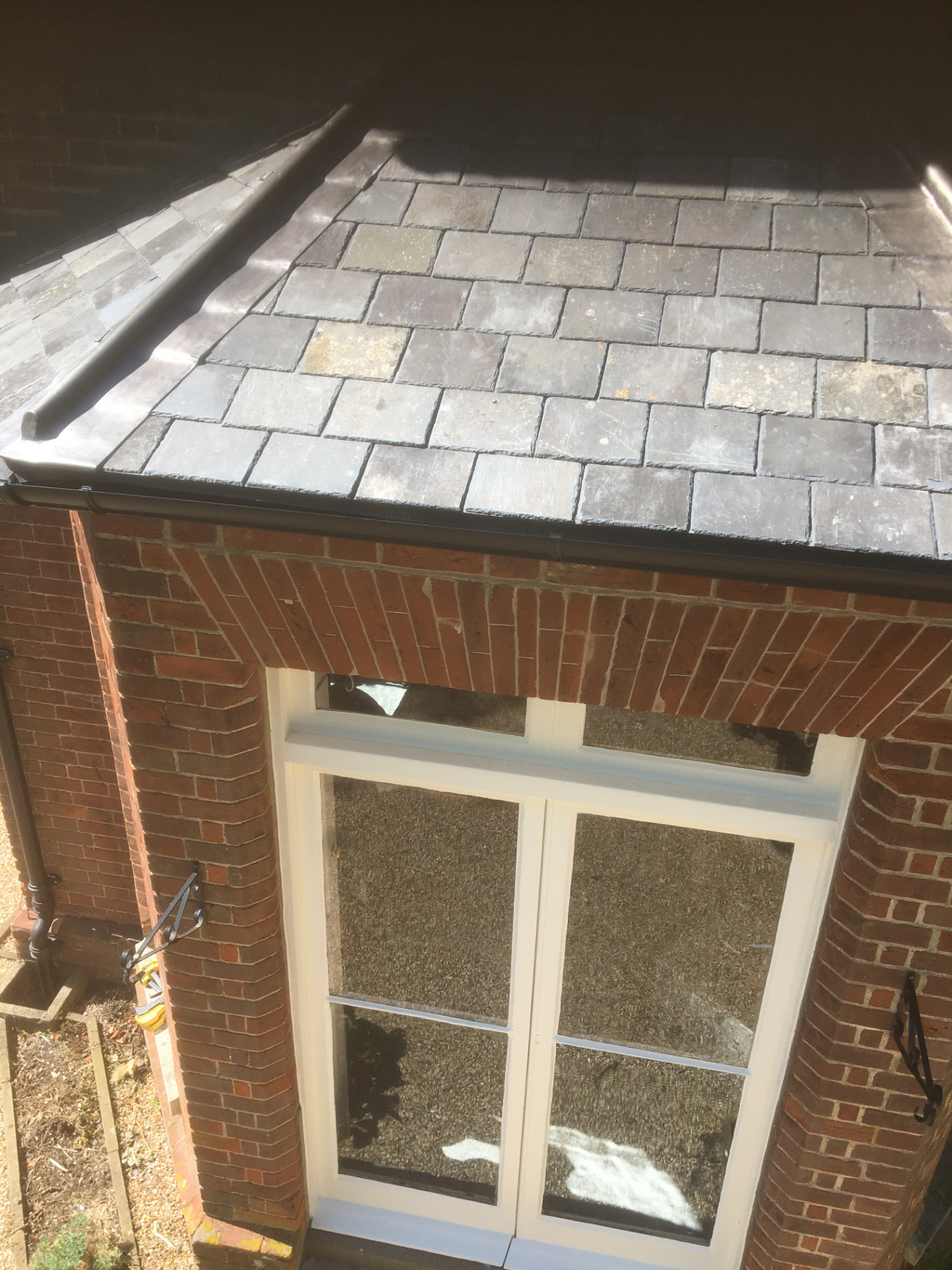 Slate roof and leadwork detail to a bay window